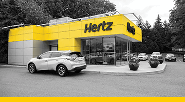 yellow hertz local edition location with vehicle in front