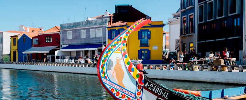 front of colorful moliceiro boat moored in the canal of the Ria de Aveiro