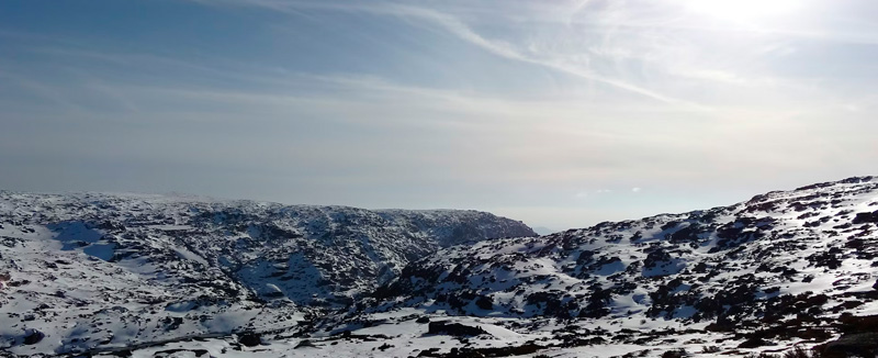 vista da serra da estrela coberta de neve num dia solarengo