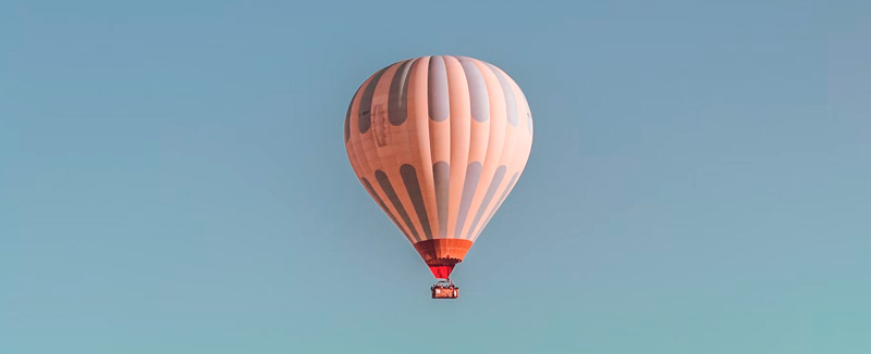 Hot air balloon in the sky with a clear blue background