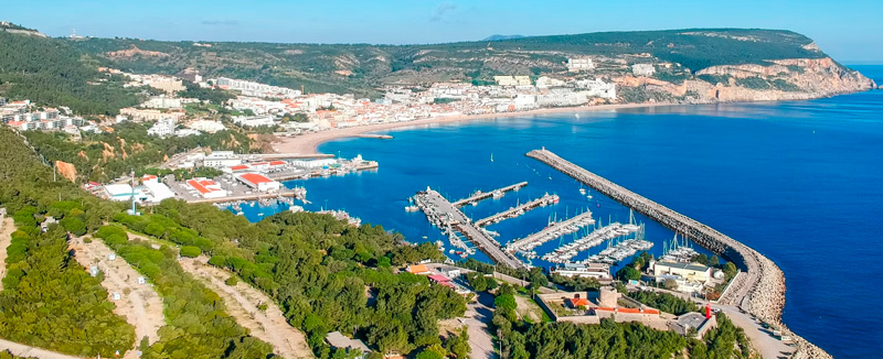 Aerial view of a marina with boats docked along the Portuguese coast.