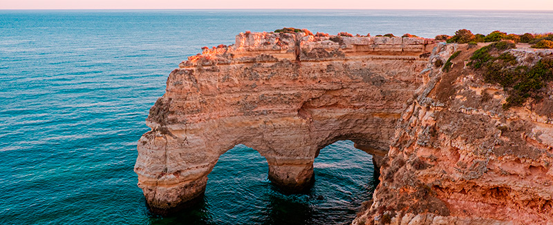 Heart-shaped rock formation at Marinha Beach in Algarve