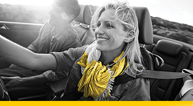 woman wearing yellow scarf driving